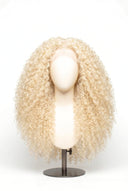 Kinky Curly Glueless Human Hair Wig in Shade 613 Porcelain Gold, Neutral Warm Bleach Blonde, by Kora Strand